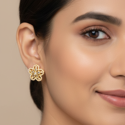 Five-petal openwork flower shape with gold-tone metal, central white stones, and a border of tiny white beads