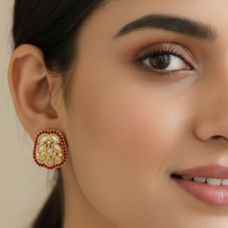Rounded-rectangle shape with gold-tone metal, multiple tear-drop and round white stones in the center